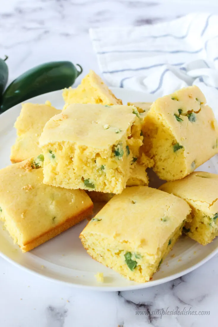 zoomed out image of cornbread on plate stacked up.