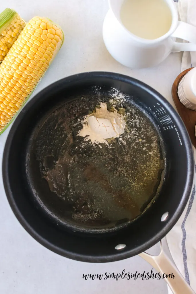 In a pot, butter is melted and flour has been added.