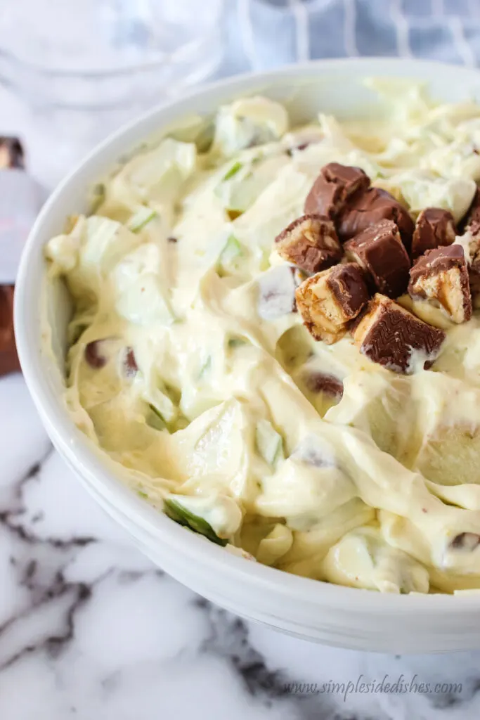 side view of snickers salad in a bowl ready to serve