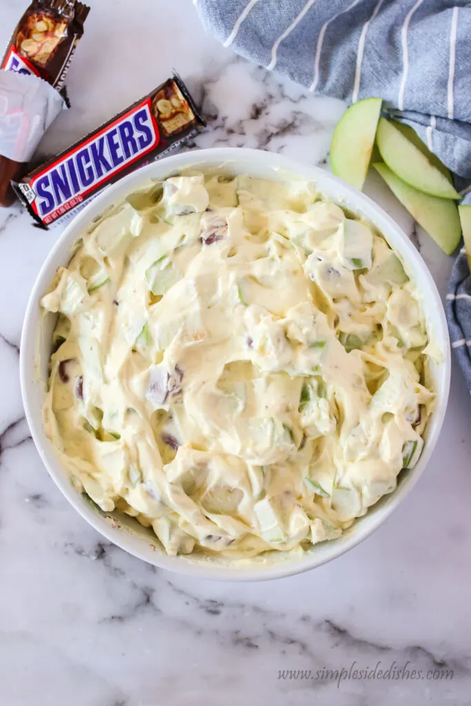 snickers apple salad in mixed together, ready to chill.