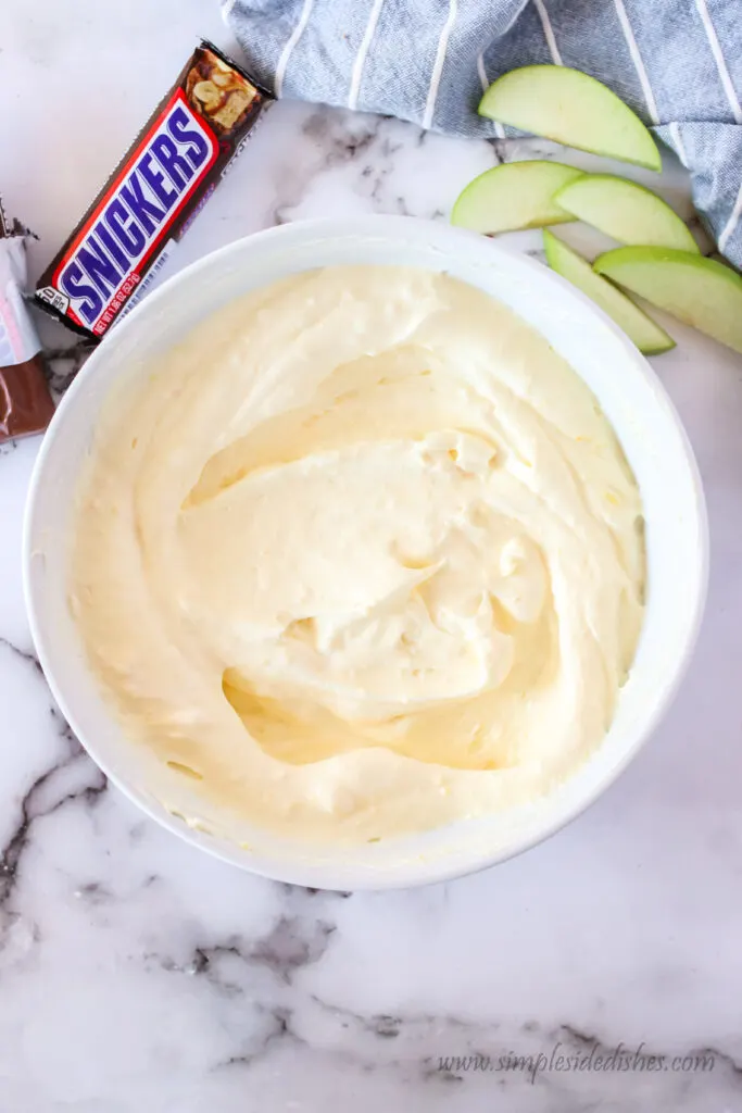 vanilla pudding and cool whip in a bowl mixed together.