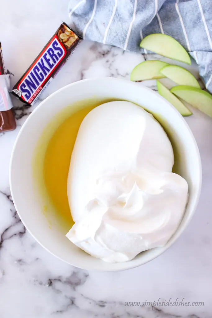 Vanilla pudding and cool whip in a bowl, unmixed