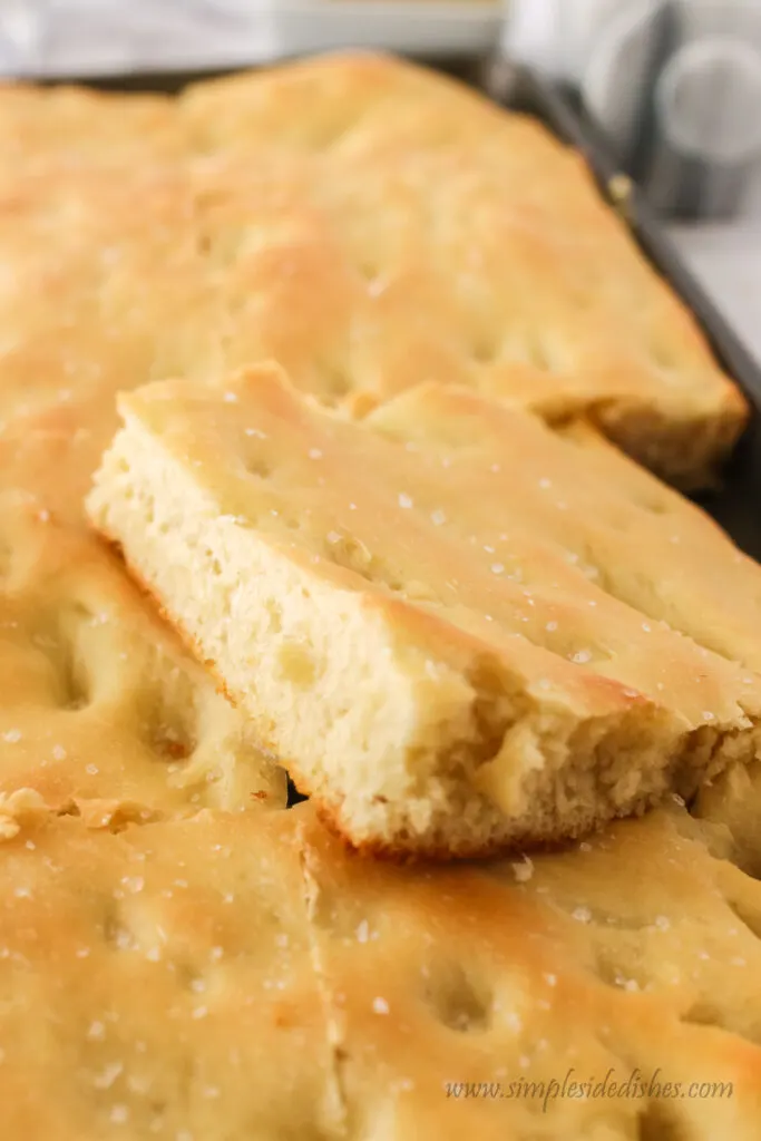 close up of focaccia bread in pan.