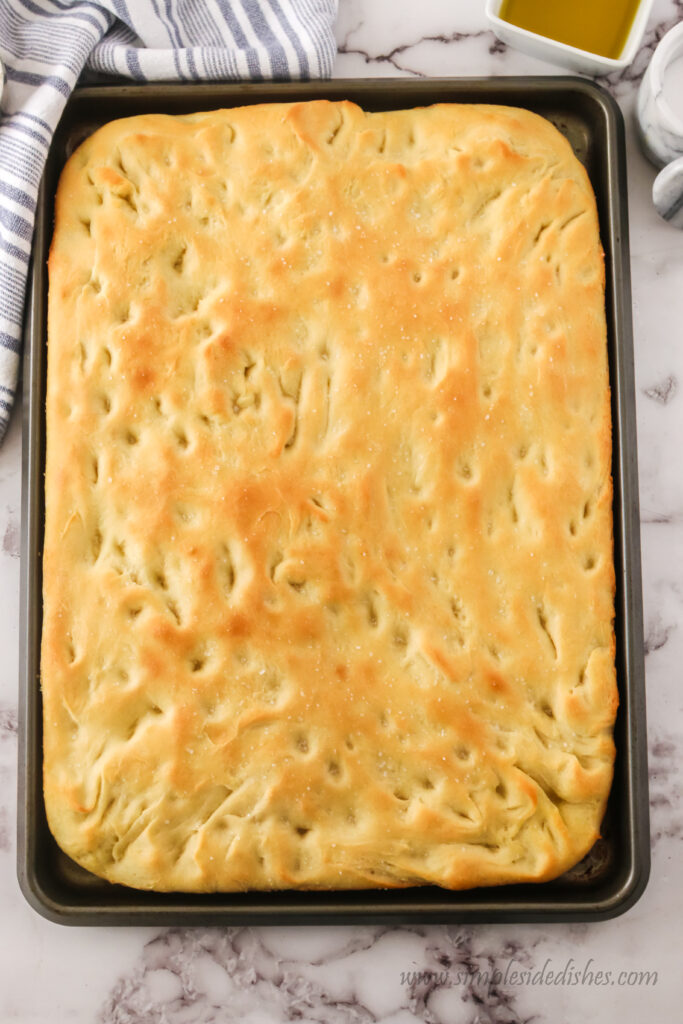 fresh baked focaccia bread in pan, uncut