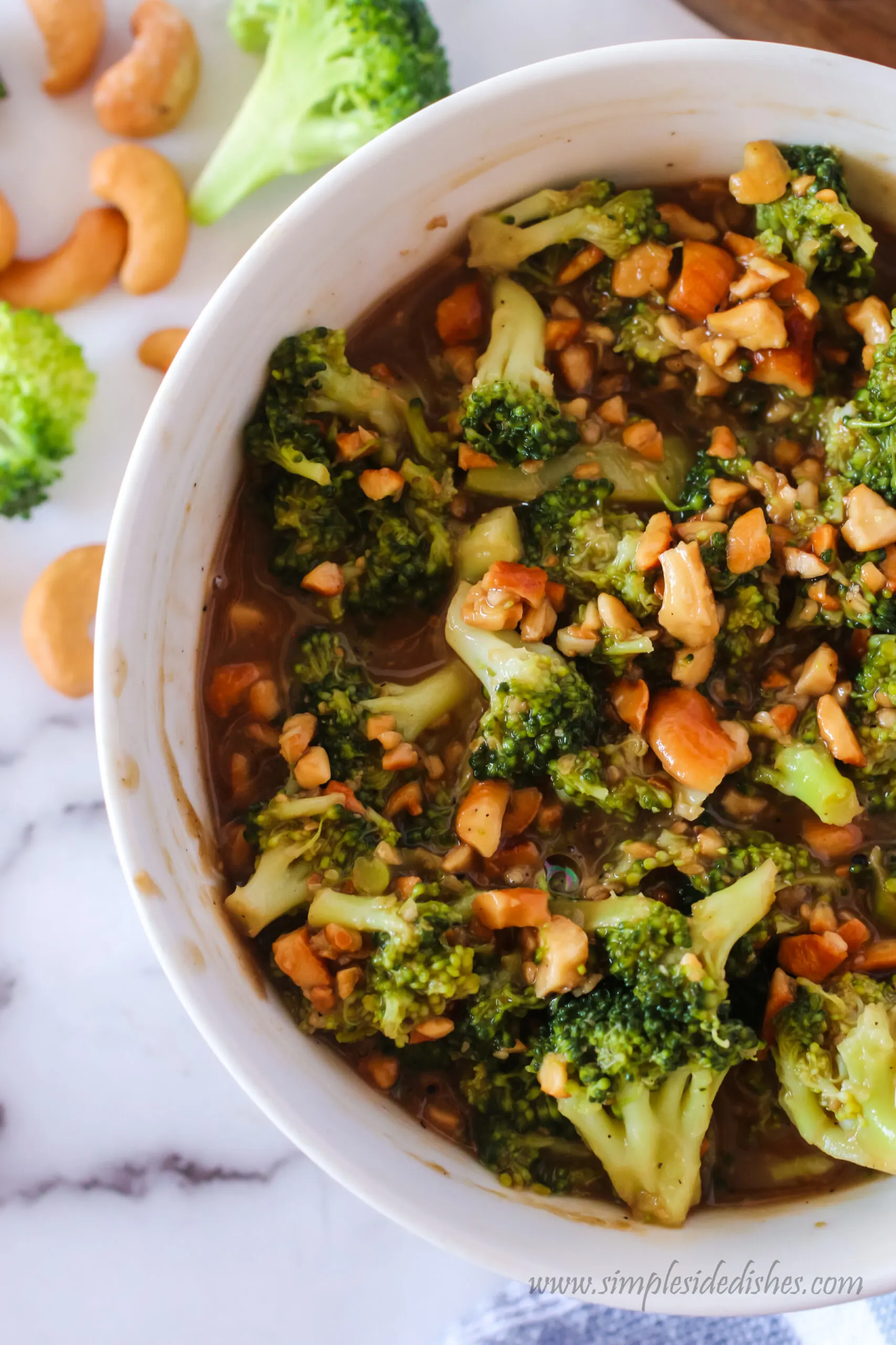 zoomed in image of cashew broccoli in a bowl