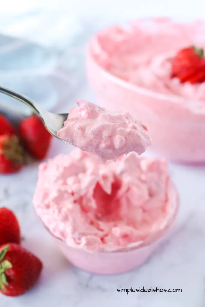 small bowl of jello fluff with a spoonful scooped out