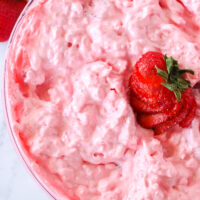 zoomed in image of strawberry fluff with strawberry sliced on top