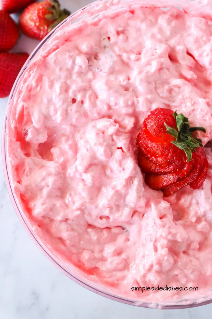 zoomed in image of strawberry fluff with strawberry sliced on top
