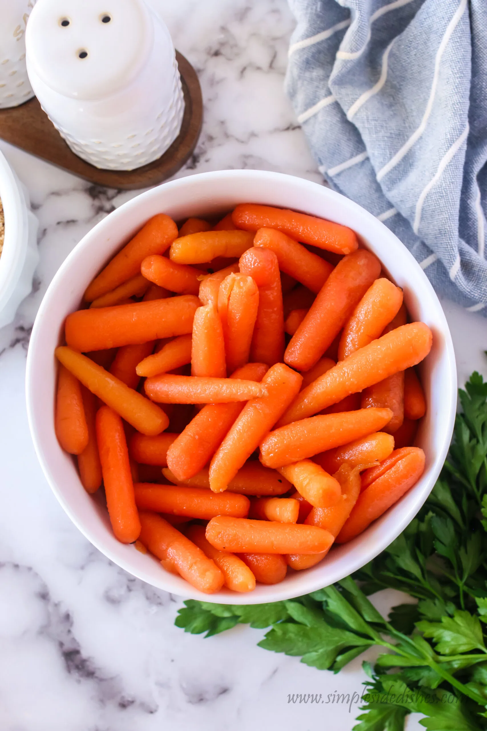 zoomed out image of cooked carrots in a bowl, ready to serve