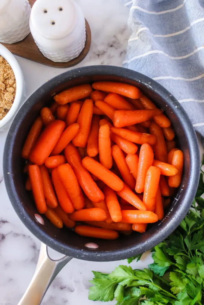 butter and sugar melted and dissolved over carrots in pot.