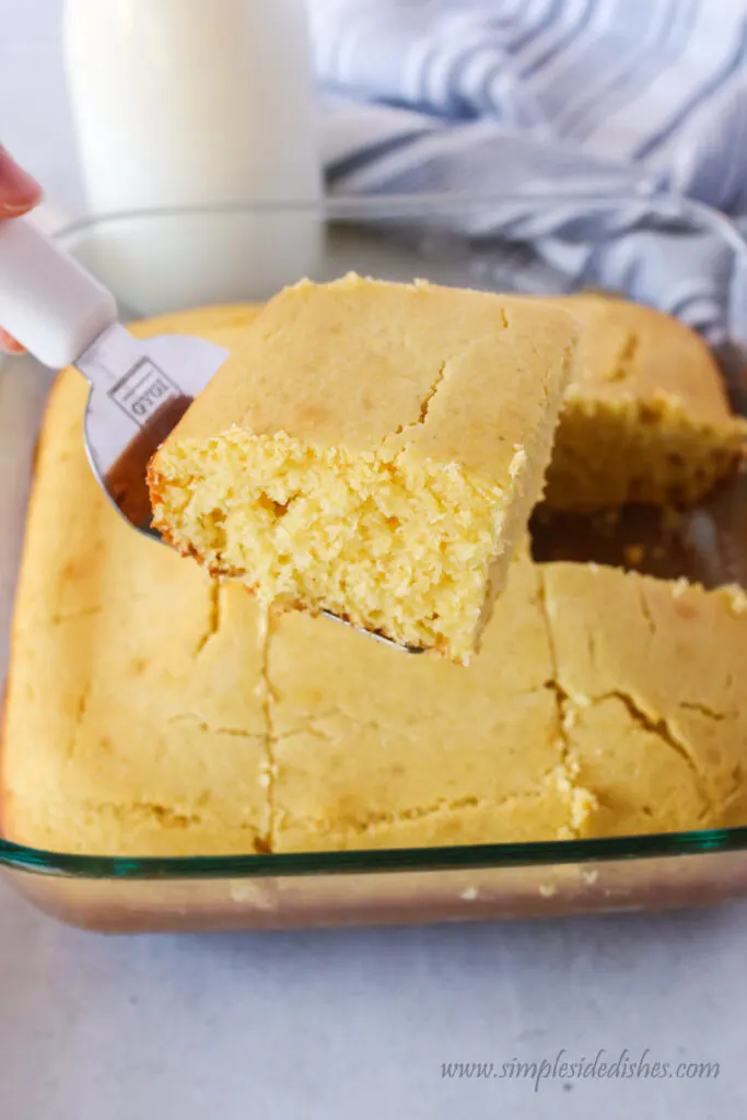 slice of cornbread held up by a spatula