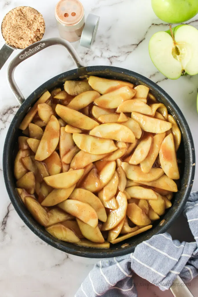 fried apples with brown sugar glaze in skillet