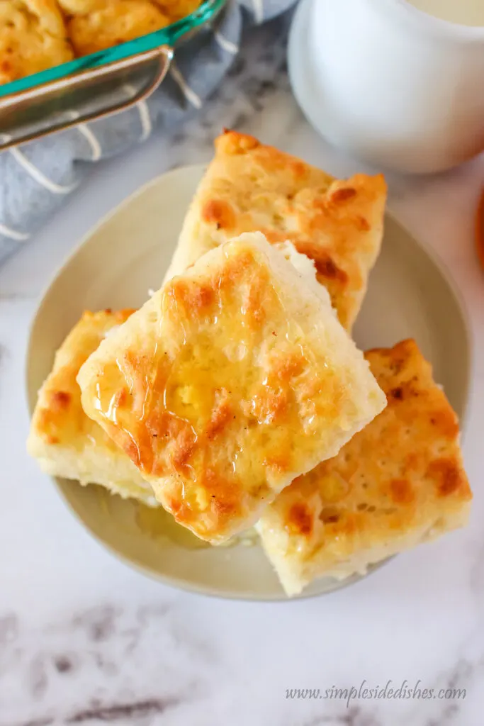 4 biscuits on a plate stacked high. Image taken from the top looking down.