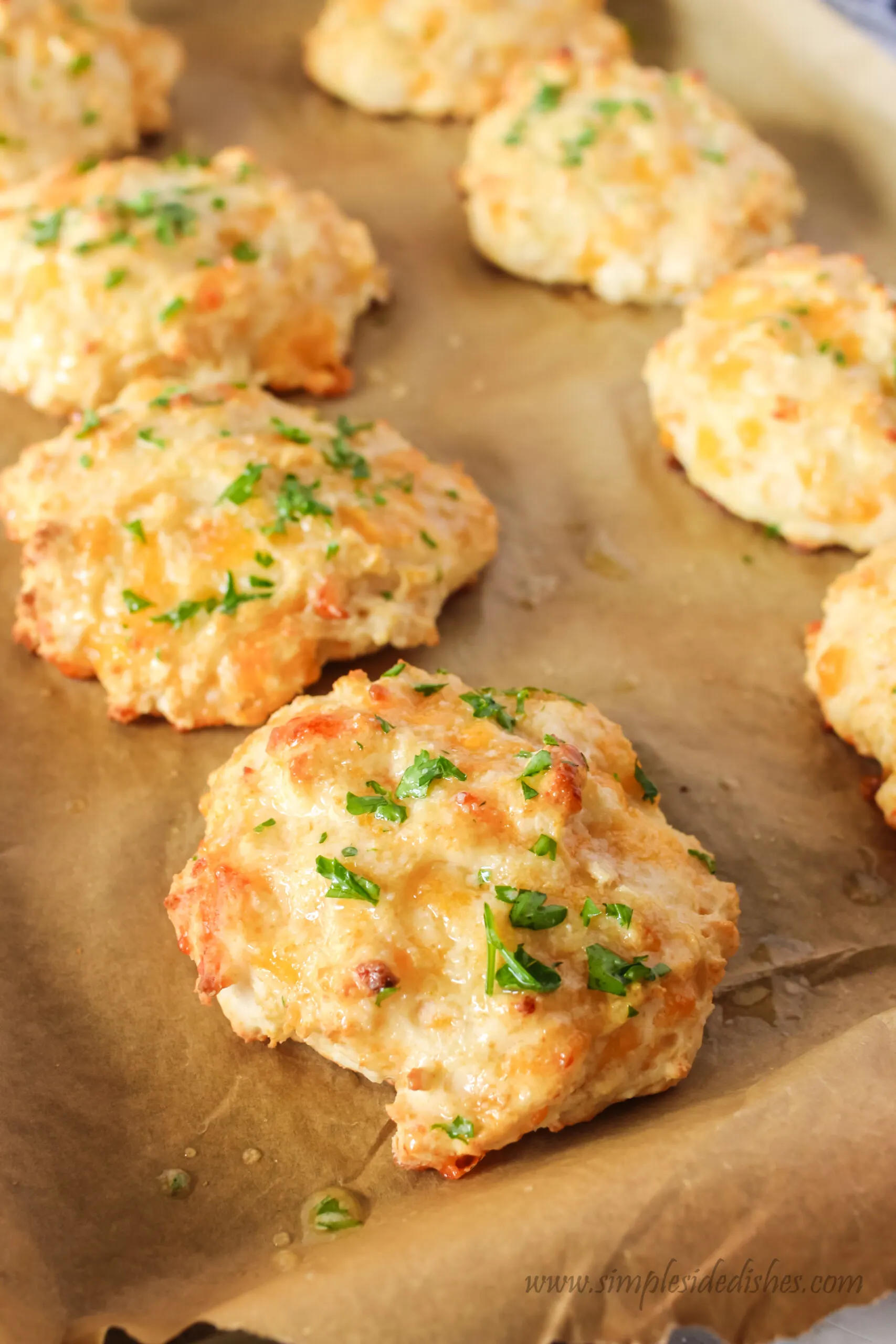 side view of biscuits on parchment paper