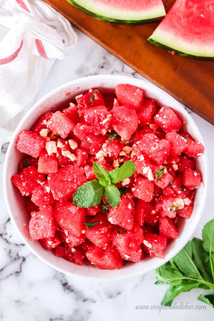 watermelon salad with a sprig of mint on top, ready to serve