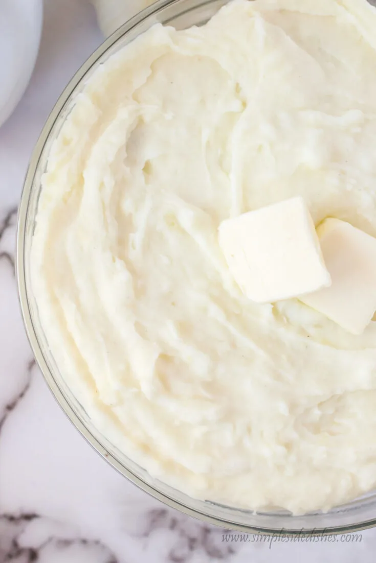 view of mashed potatoes in serving bowl from the top looking down.