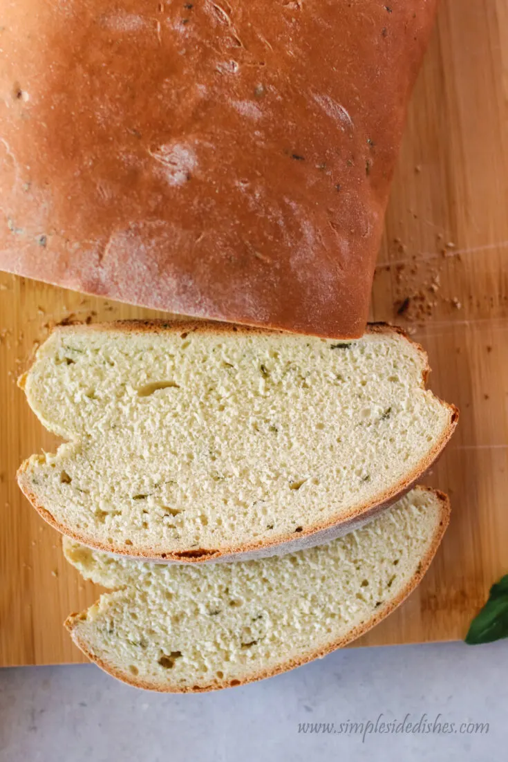 close up of bread on cutting board with two slices