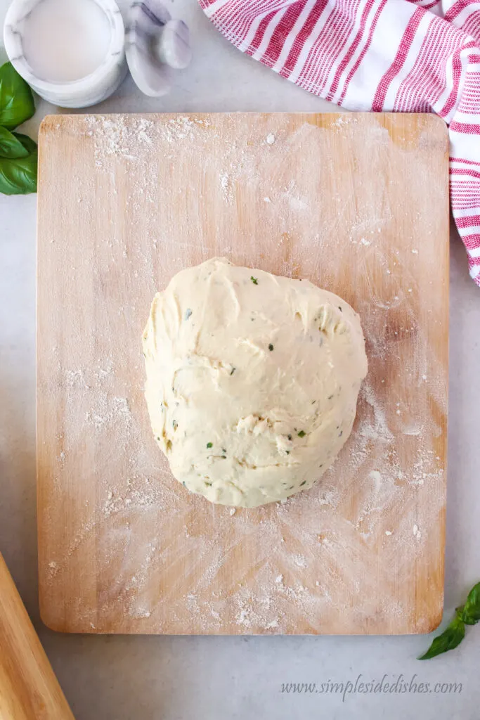 basil bread mixed and on a cutting board