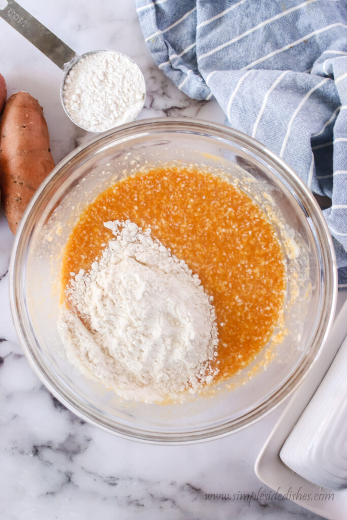 yeast, sugar, milk, flour, sweet potato puree, butter, salt and eggs in a bowl, unmixed