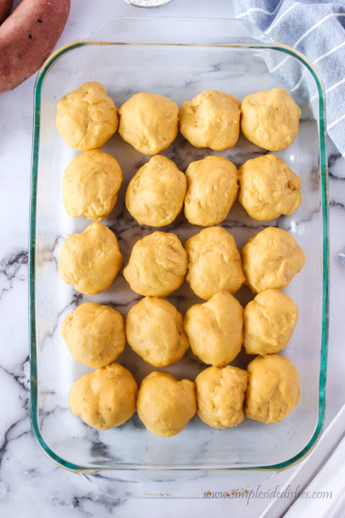 dough balls unrisen in casserole dish.