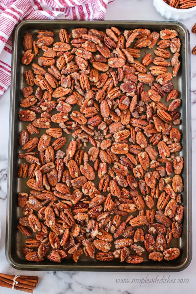 coated pecans laid out on cookie sheet, ready to bake