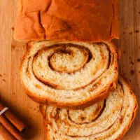 swirled bread on cutting board with 2 slices cut off