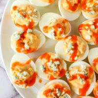 zoomed in image of buffalo blue cheese deviled eggs on platter