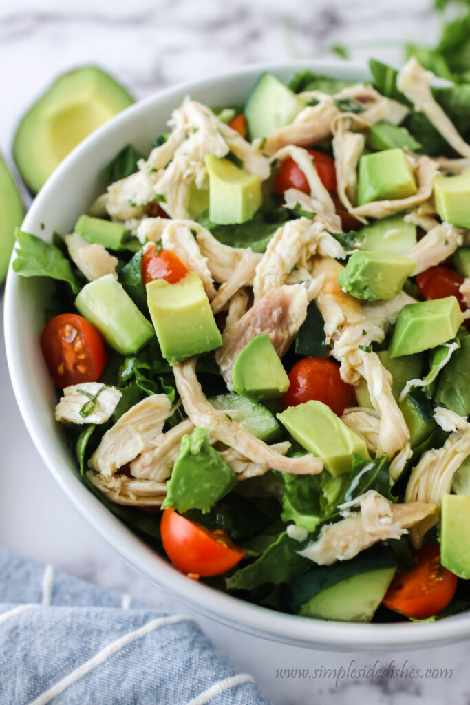 zoomed in image of avocado chicken salad in serving bowl