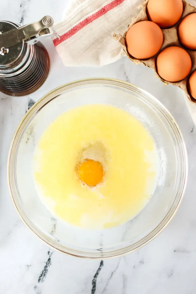 egg milk, syrup and butter in a bowl, unmixed