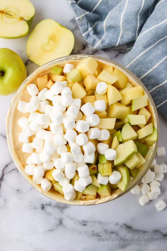 apples and marshmallows add to fluff mixture