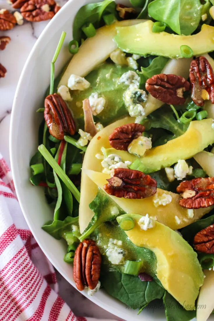 zoomed in image of salad in bowl with dressing