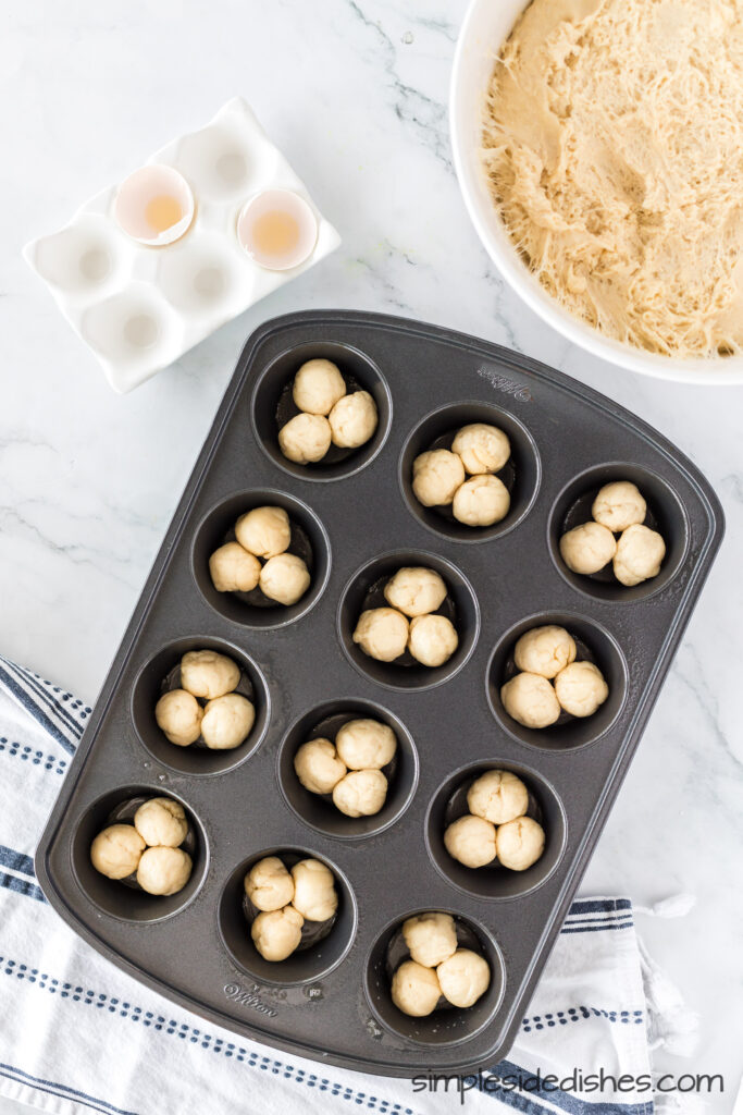 3 balls of dough in each muffin tin to create the clover leaf pattern.