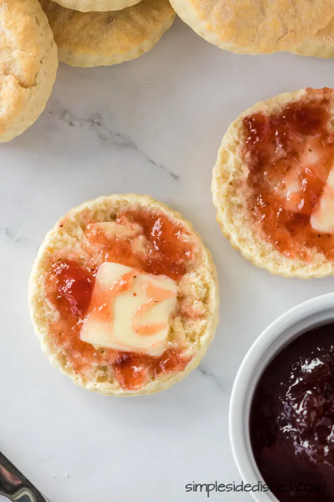 side view of open biscuit with butter and jelly