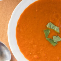 zoomed in image of homemade roasted tomato basil soup in a bowl