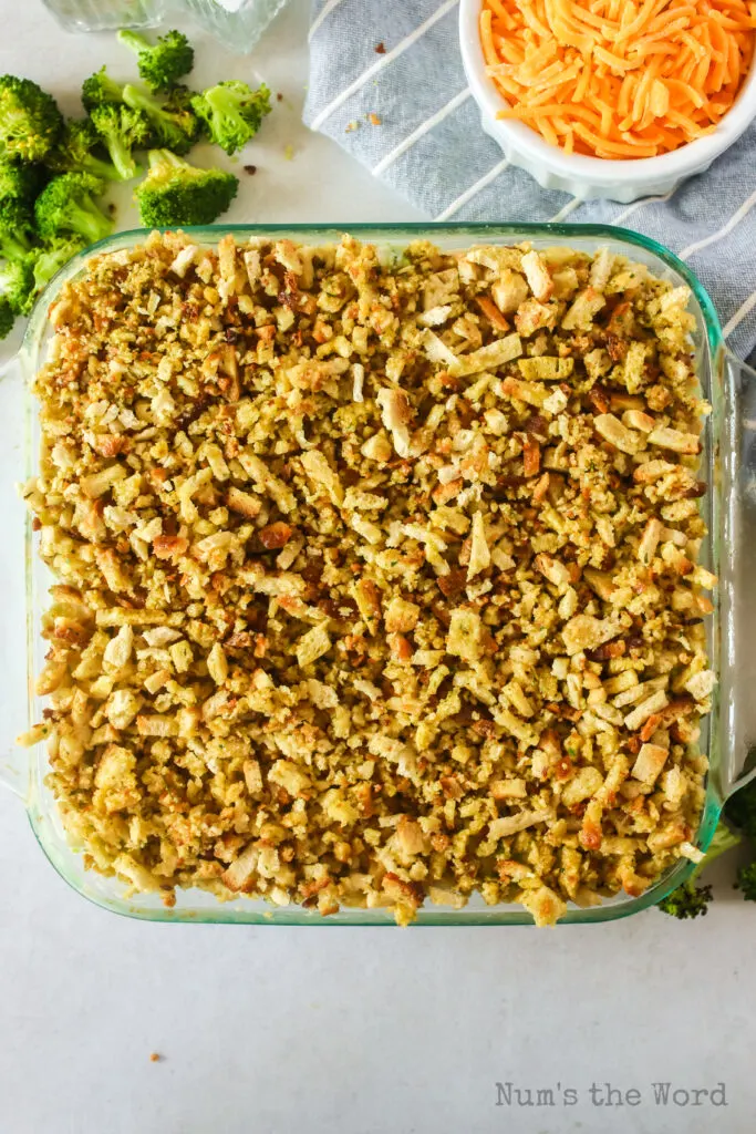 stuffing mix scattered on top of cheesy broccoli casserole mix