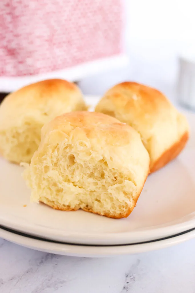 3 fluffy dinner rolls on a plate