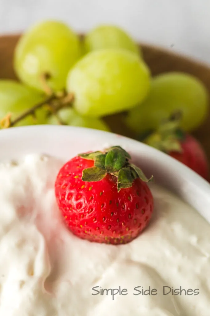 zoomed in image of fruit dip with a strawberry