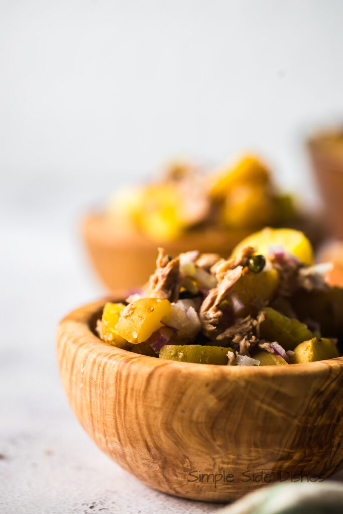 side view of tuna fish and potato salad in bowl