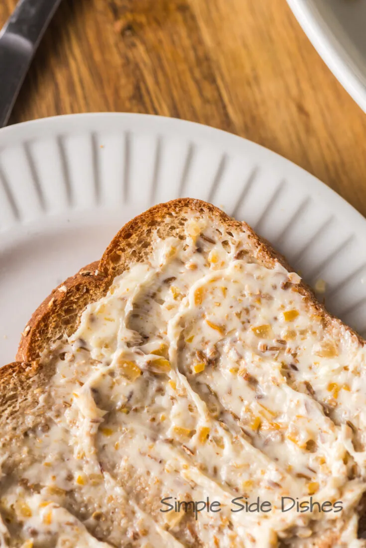 butter spread on a slice of bread.
