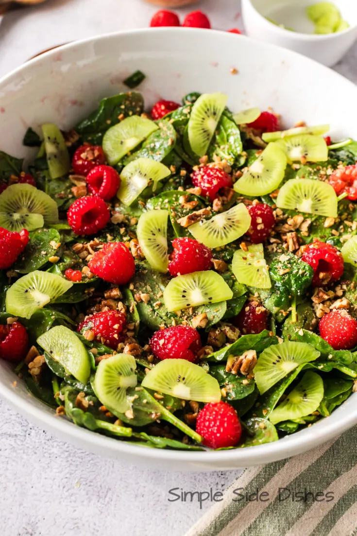 finished salad with raspberries, kiwi and pecans, ready to serve