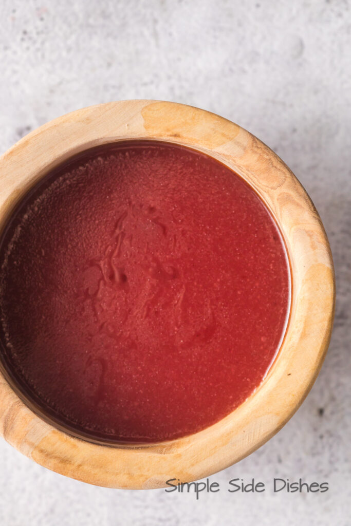 3 ingredient raspberry jam salad dressing in a small containers.