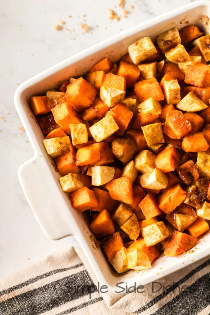 zoomed in image of sweet potatoes, apples and brown sugar sprinkled on top but not baked.