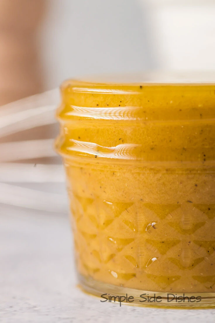 side view of vinaigrette dressing in a jar, ready to serve.