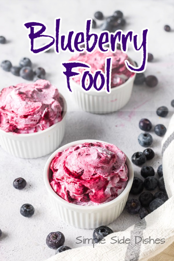 Main image for Blueberry Fool Recipe. Small bowls of dessert on counter with blueberries scattered around.