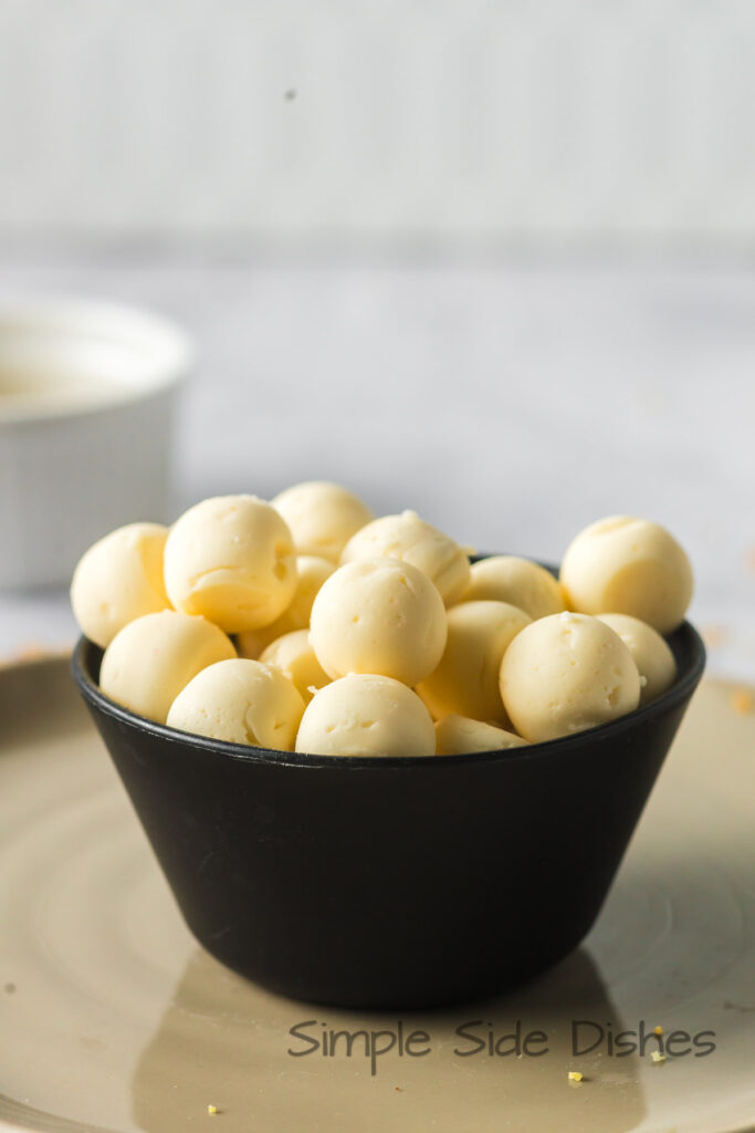 side view of butter balls in a bowl, ready to serve.