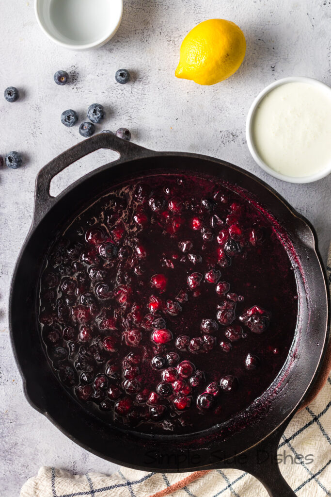 Blueberries cooked in skillet.