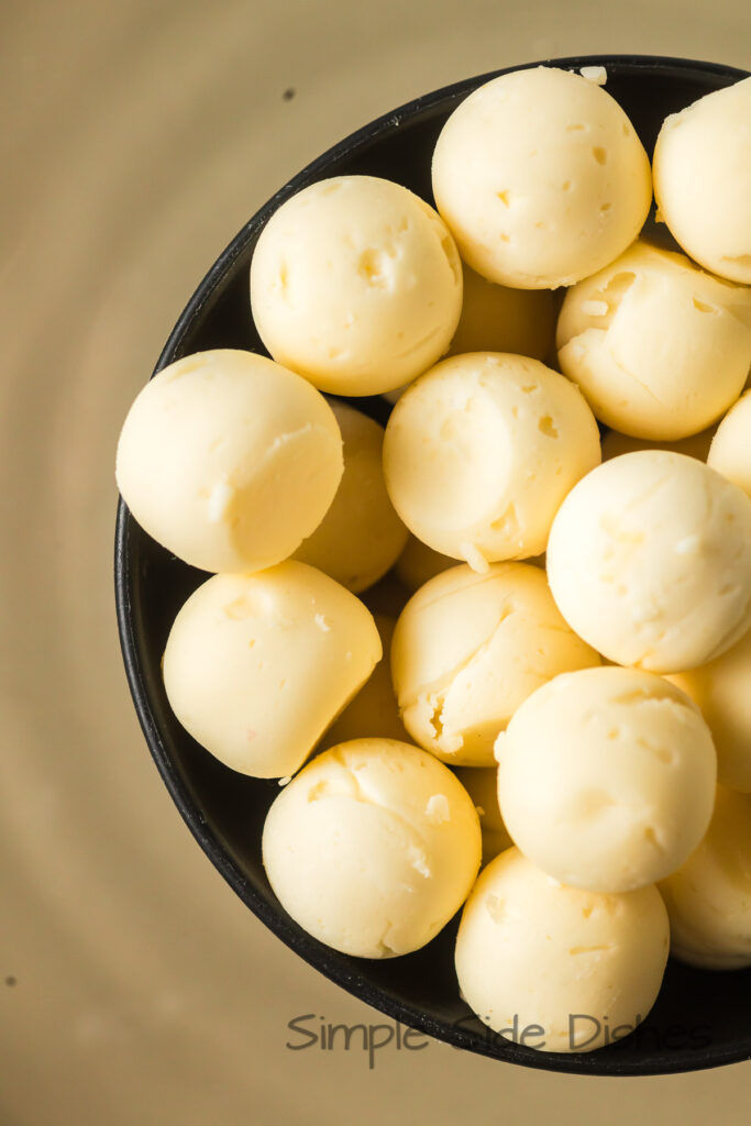 molded butter balls in a bowl, ready to serve.