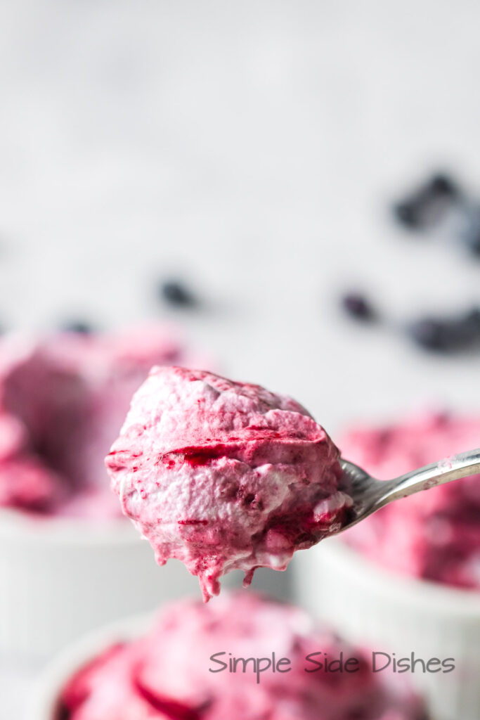 a spoon scooping a portion of fool and showing it to the camera.