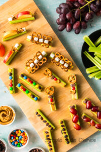 zoomed out image of celery animals laid out on a serving board