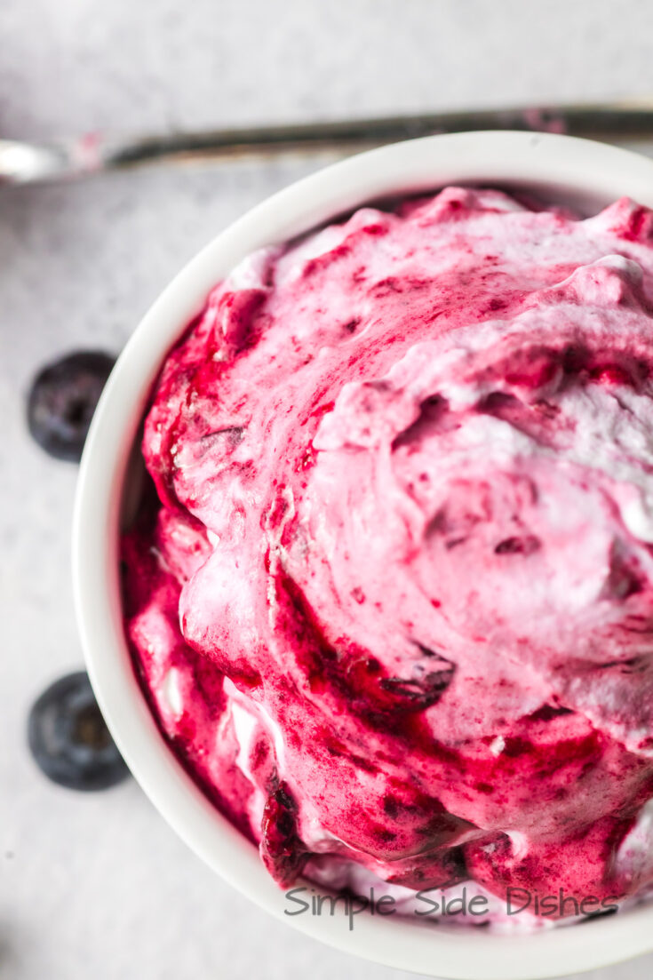 zoomed in image of blueberry fool in a bowl.